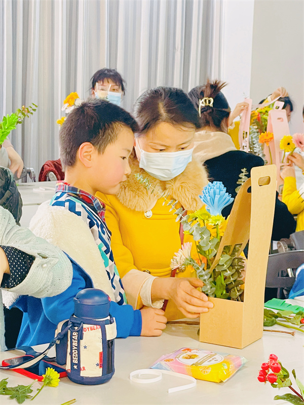 图二 妈妈在帮助孩子插花.jpg